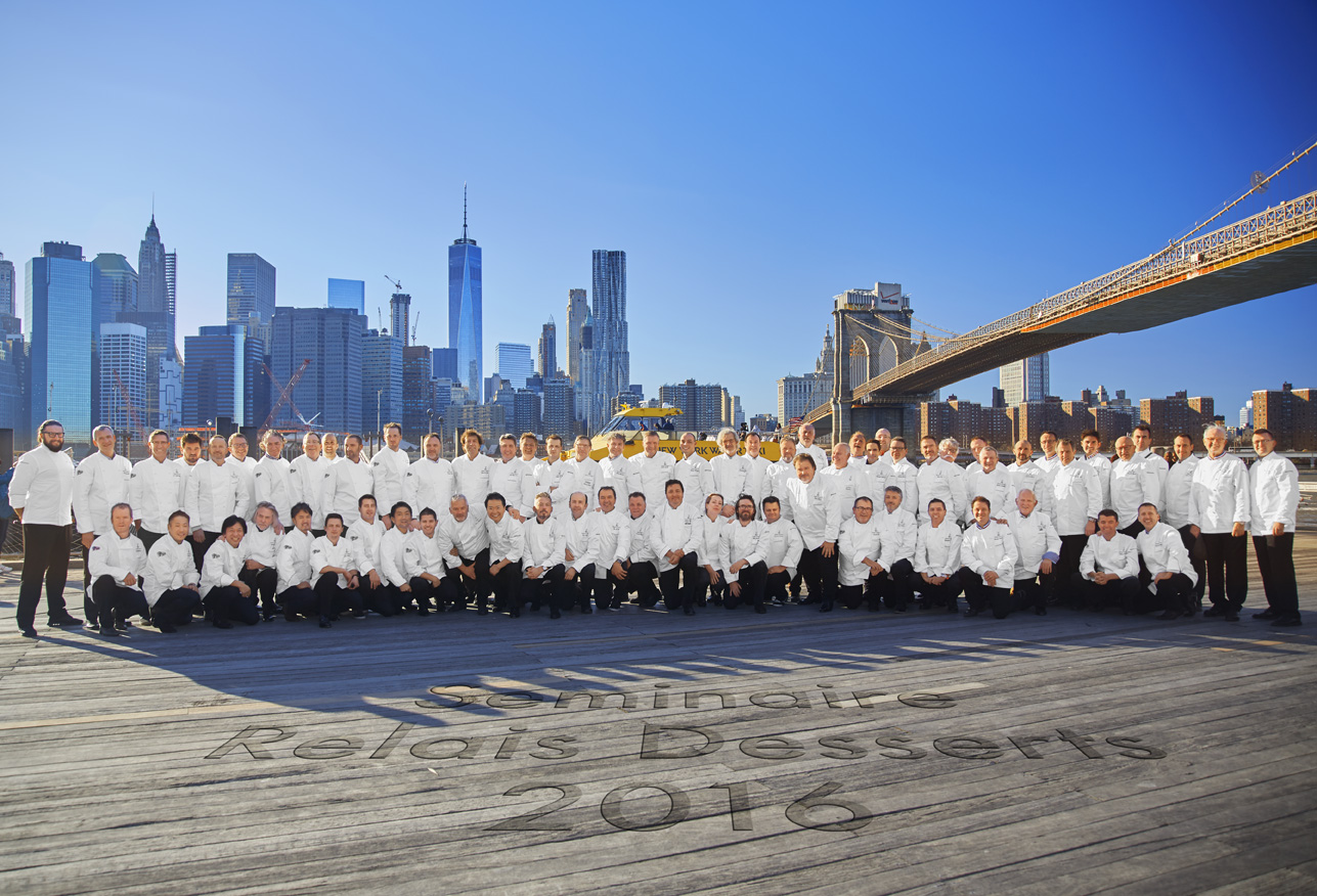 Groupe de chefs en uniformes blancs posant pour une photo